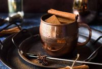 Chai-Spiced Moscow Mule with Charred Cinnamon Twist