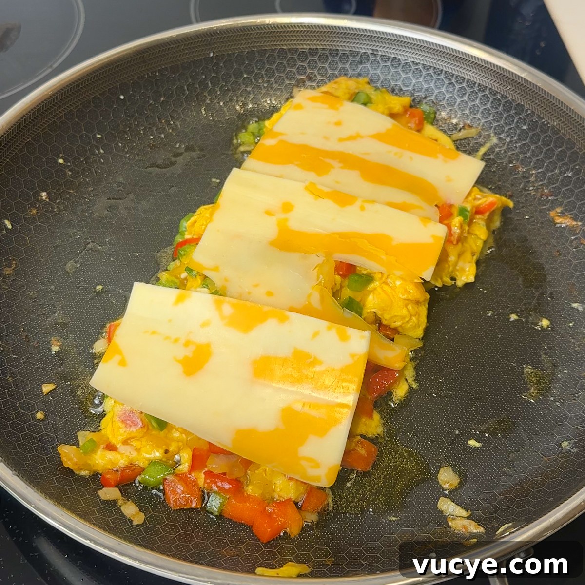 Scrambled eggs with cheese melting