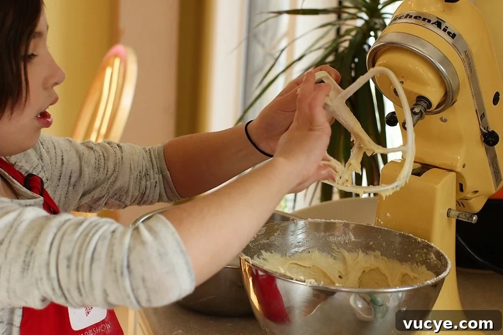 Seven-Minute Frosting Recipe Kids Can Make for Birthday Cakes 5 cleaning the beaters for the birthday cake with seven minute frosting