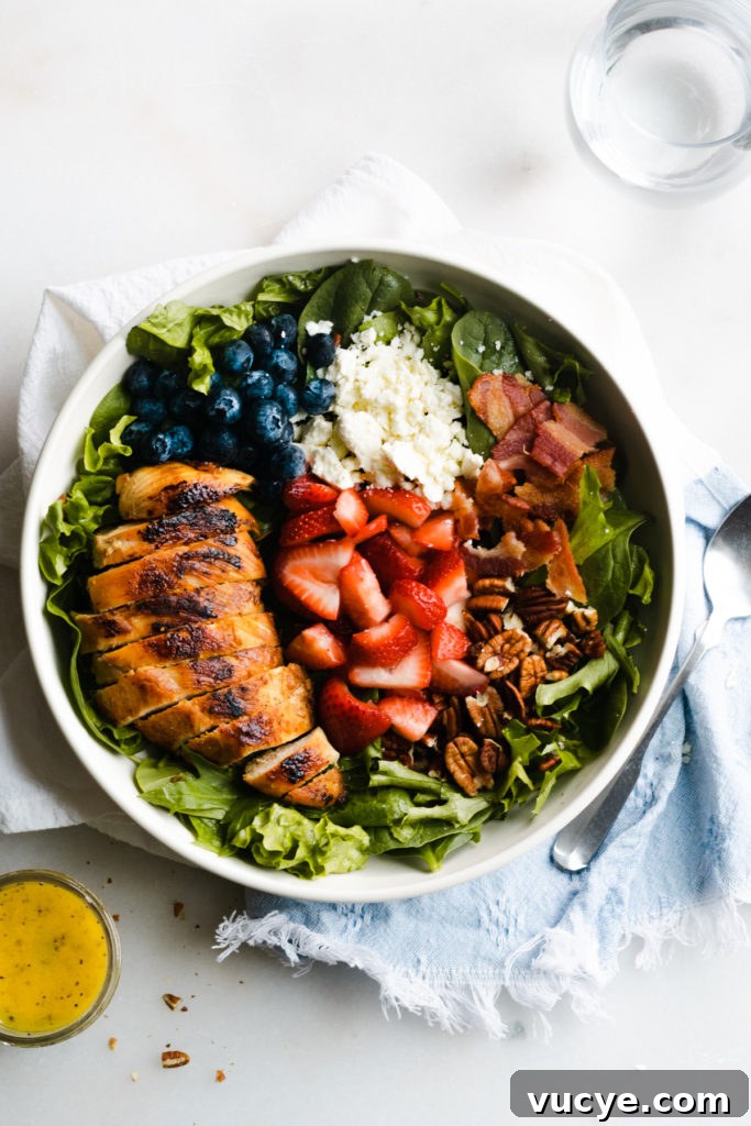 Strawberry Chicken Salad with Bacon and Poppy Seed Dressing 5 Strawberry salad ingredients arranged in a bowl.