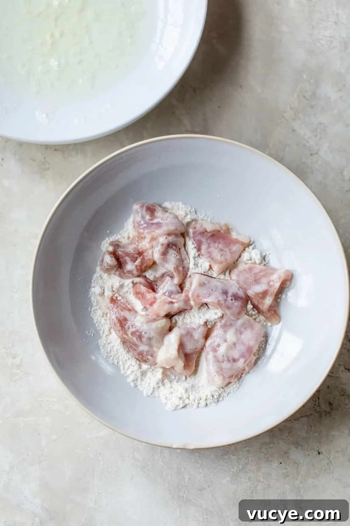 Low-Calorie Sweet and Sour Chicken Recipe for Weeknight Meals 4 bowl with raw chicken coated in flour
