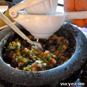 Adding fresh squeezed lime juice to salsa