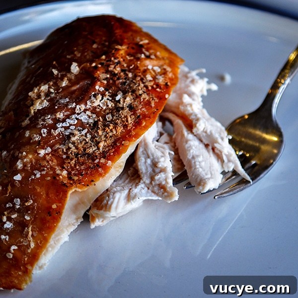 Perfect Roast Chicken: Two Foolproof Oven Methods 5 A slice of perfect roast chicken on a plate with a fork.