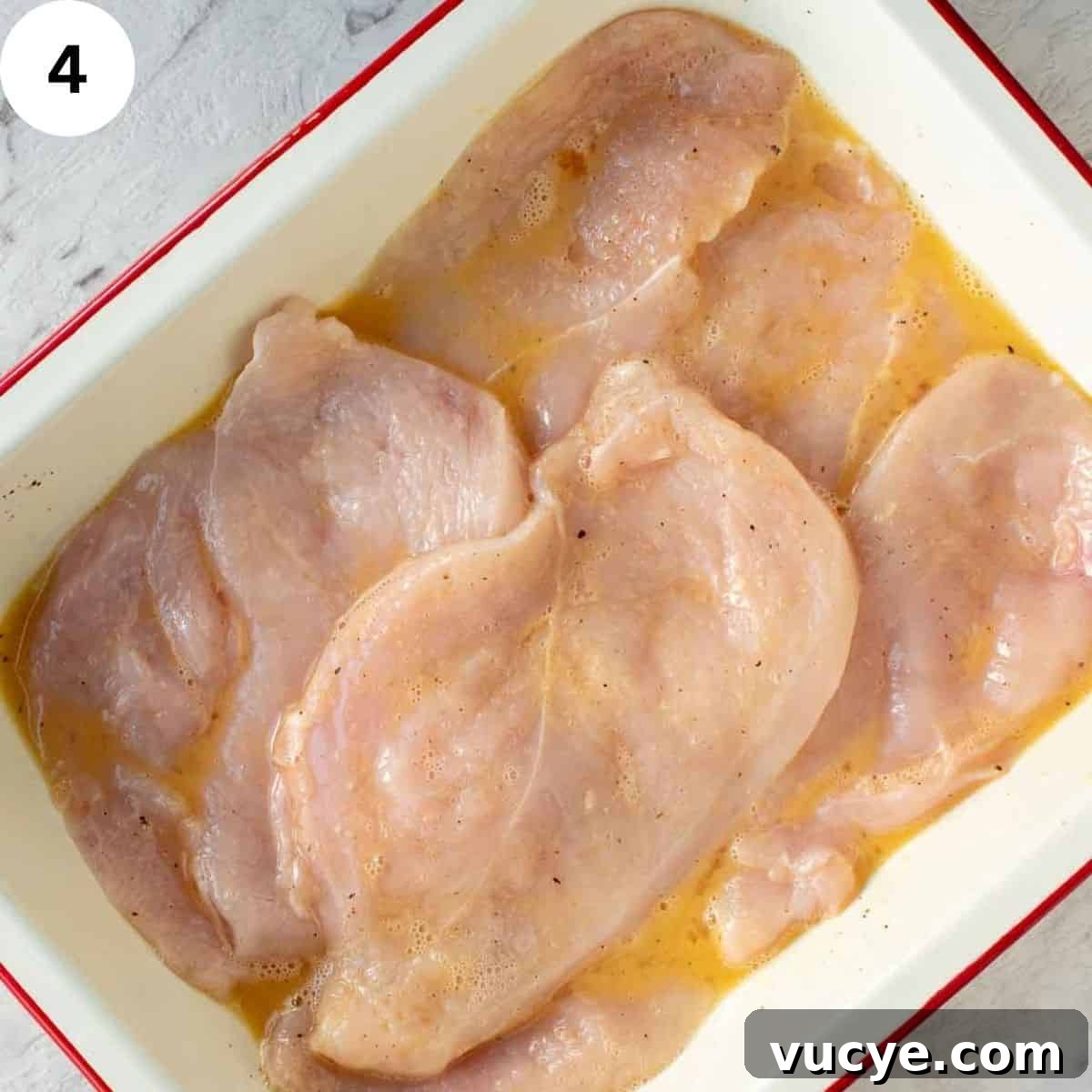 Chicken breasts in eggy marinade.
