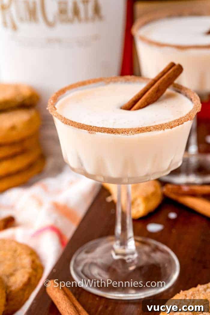 A snickerdoodle cocktail garnished with a cinnamon stick.