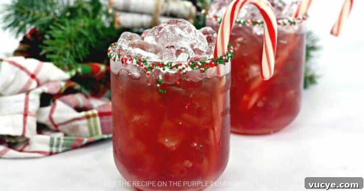 A Christmas elf cocktail garnished with whipped cream and a candy cane.