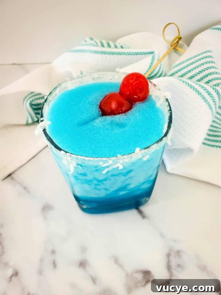 A blue Jack Frost cocktail garnished with maraschino cherries.