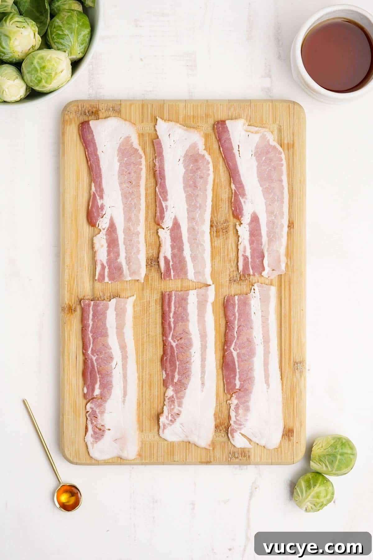 Bacon strips laid out on a cutting board.