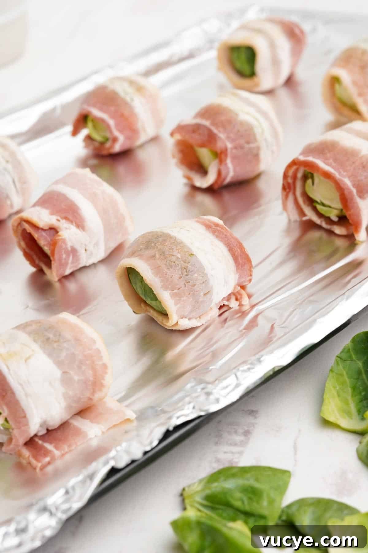 Bacon brussels sprouts on a baking tray.