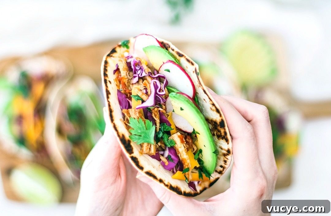 Instant Pot Chipotle Chicken Tacos | Killing Thyme Instant Pot Chipotle Chicken Tacos in hand