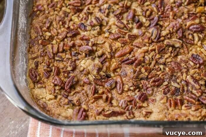 Ultimate Pumpkin Crunch Cake Recipe for Fall Dessert 6 Close up of pumpkin crunch dump cake layers in a glass baking dish.