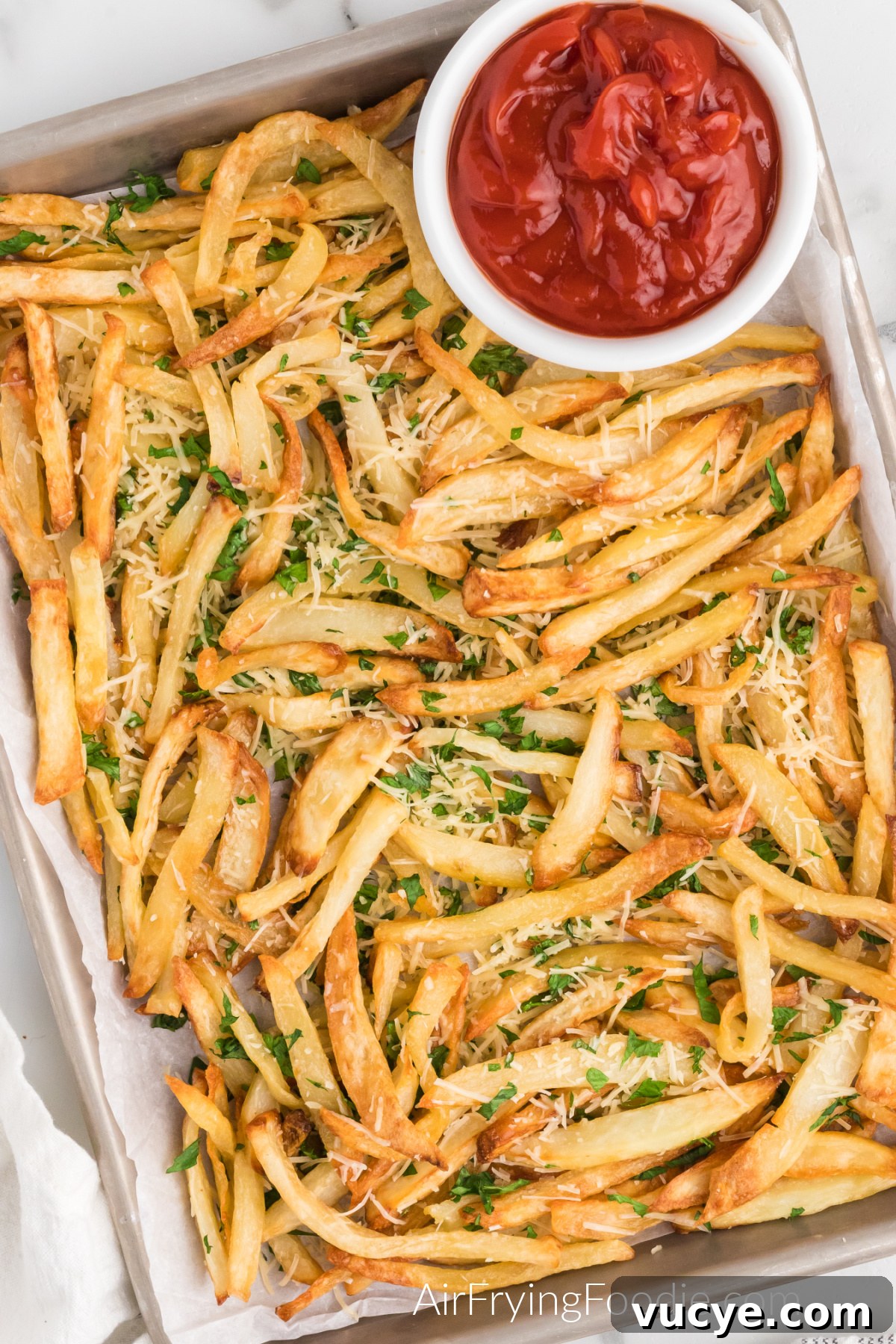 Crispy Air Fryer Truffle Fries Recipe 6 Truffle fries on a serving platter with a side of ketchup.