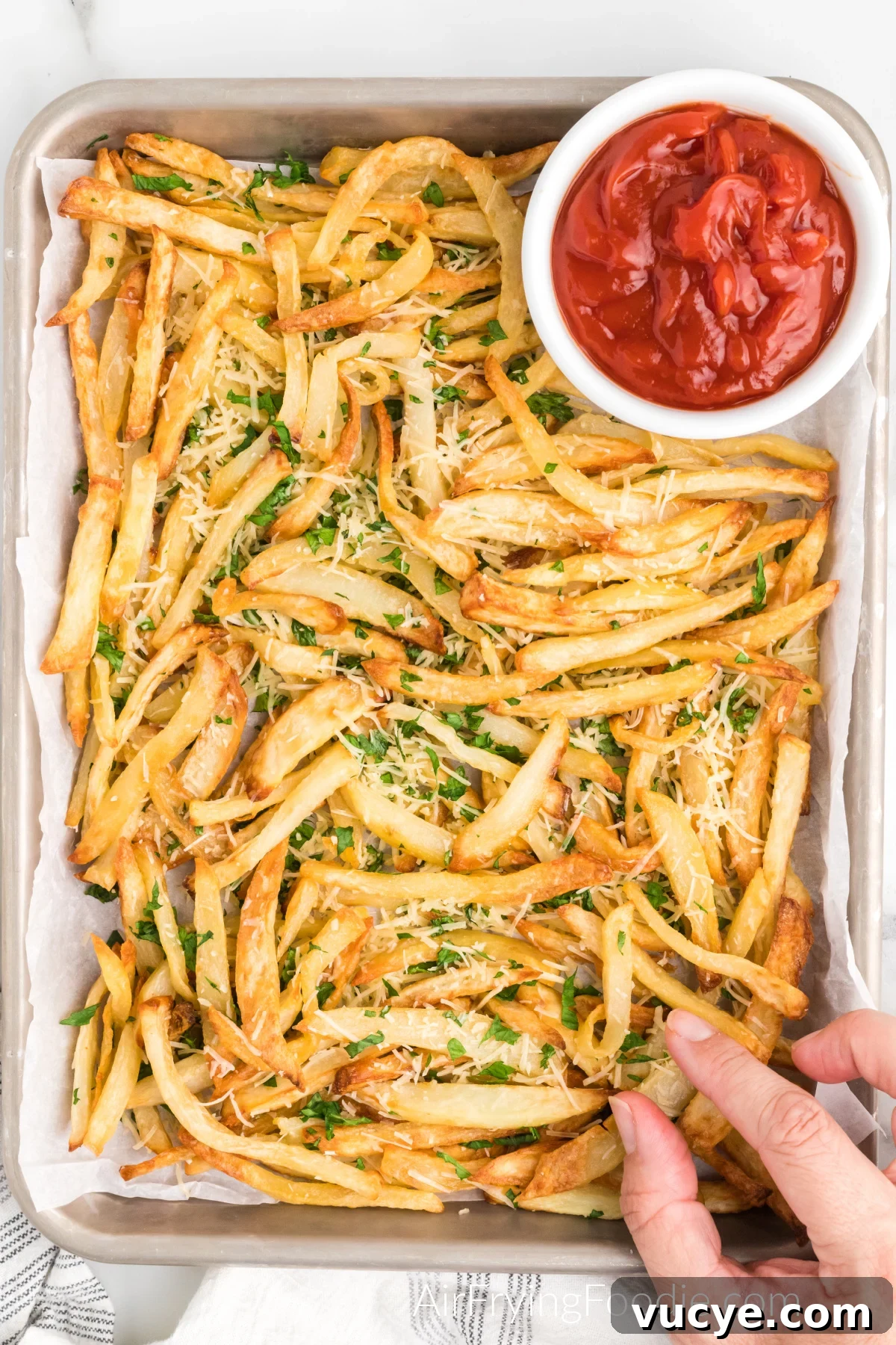 Crispy Air Fryer Truffle Fries Recipe 5 Truffle fries on a serving platter with a side of ketchup.