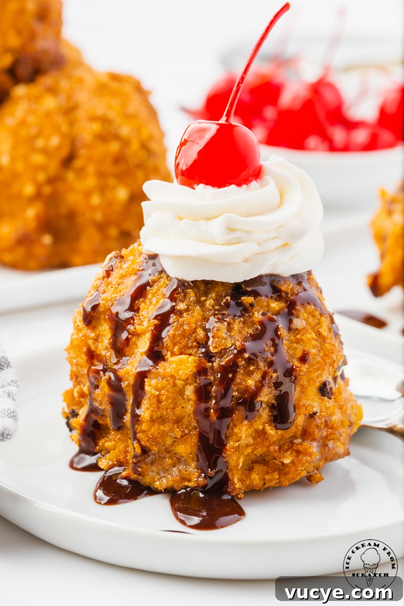 Homemade Fried Ice Cream Recipe: Crispy Shell & Creamy Center 2 A single scoop of fried ice cream topped with chocolate syrup, whipped cream, and a marachino cherry