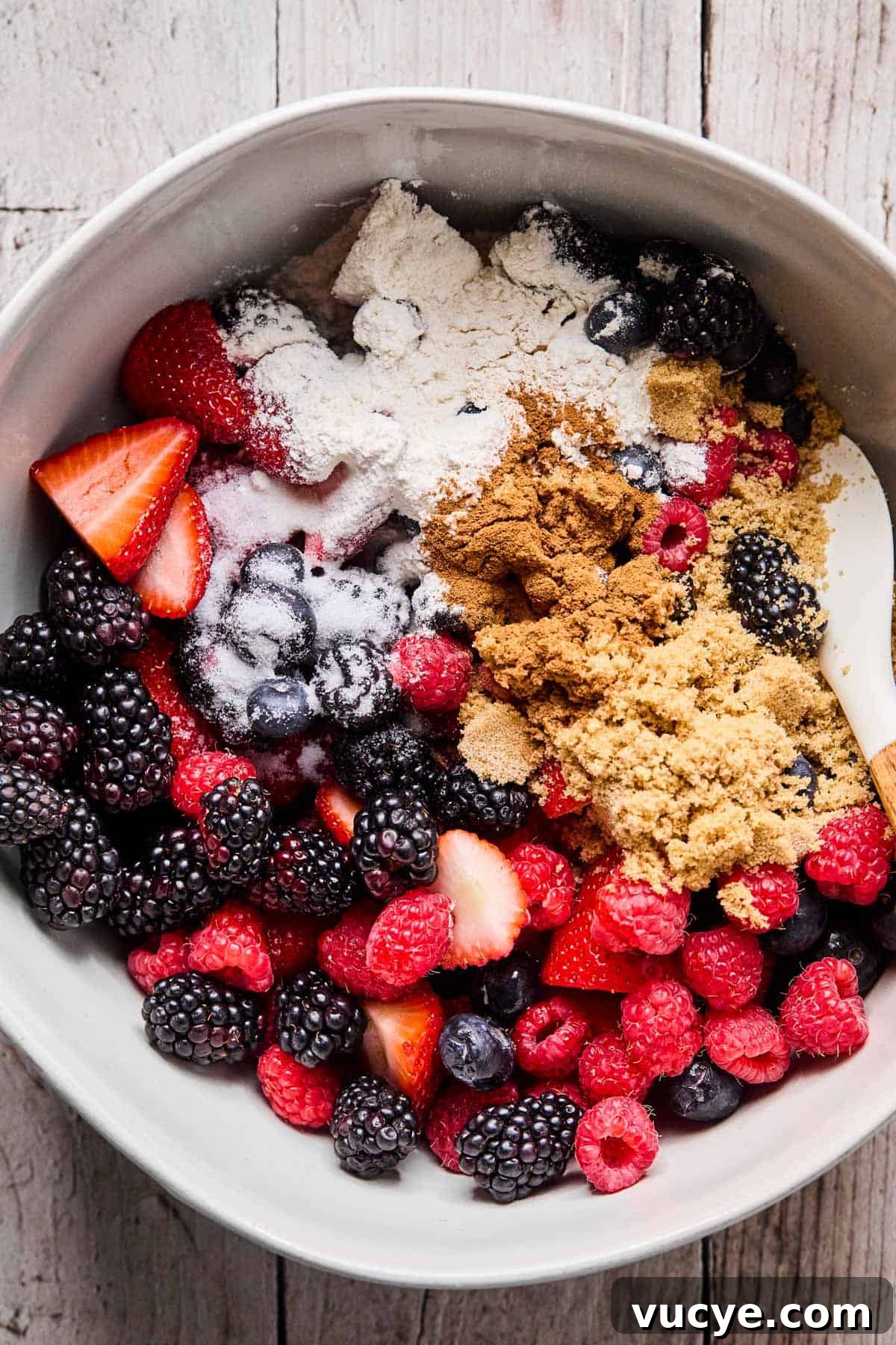 Naturally Sweetened Gluten-Free Berry Crisp Recipe 6 berries, salt, vanilla, brown sugar placed in a mixing bowl