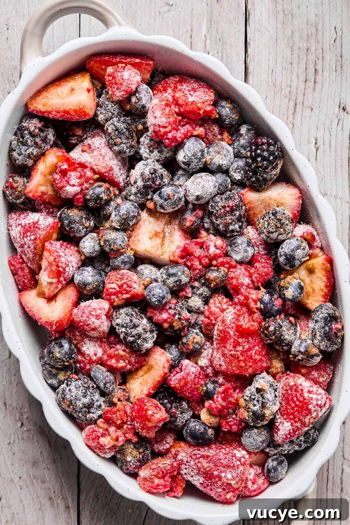 Naturally Sweetened Gluten-Free Berry Crisp Recipe 7 berry, sugar, flour mixture added to a baking dish and set aside for gluten free berry crisp