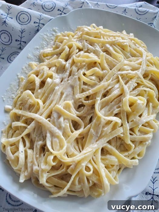 Olive Garden Alfredo Sauce Recipe with Video Guide 3 Olive garden homemade alfredo sauce with fettuccine noodles on a white platter