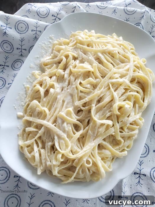 Olive Garden Alfredo Sauce Recipe with Video Guide 5 Olive Garden fettuccine alfredo on a white platter with a cloth napkin
