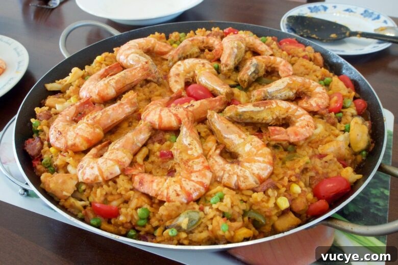 Western European Flavors: Iconic Dishes and Regional Specialties 5 Large pan of paella topped with prawns