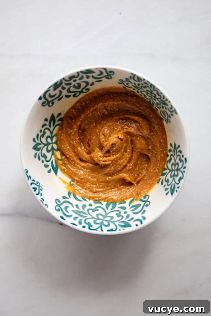 Snickers-Inspired Chia Pudding Recipe: Chocolate Peanut Butter Parfait 8 mixed peanut butter and maple syrup in a small bowl