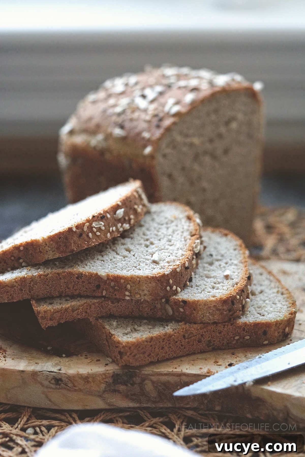Soft Gluten-Free, Dairy-Free Buckwheat Bread Recipe 2 Sliced buckwheat loaf with seeds on top + a couple of slices bent slightly to show pliability