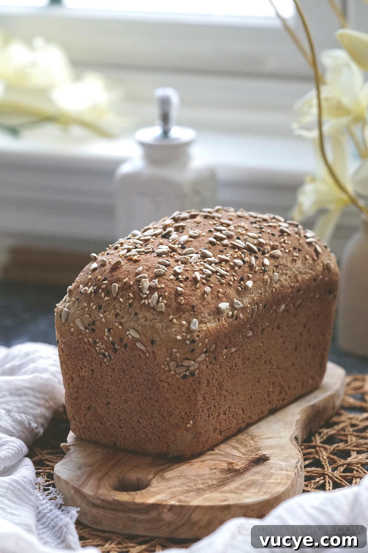 Soft Gluten-Free, Dairy-Free Buckwheat Bread Recipe 8 browned Buckwheat bread loaf baked through (gluten-free dairy-free) cooling on a wooden board.