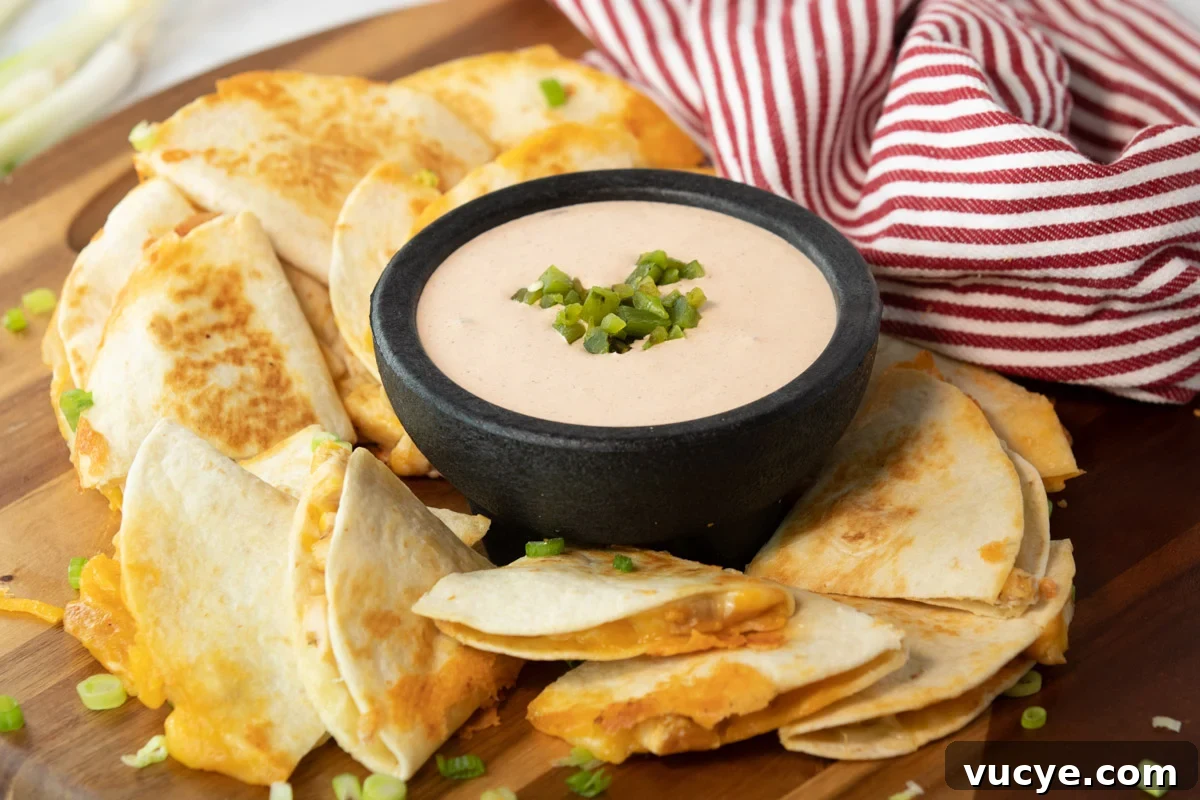 Taco Bell Quesadilla Sauce: Copycat Recipe & Serving Tips 3 bowl of taco bell quesadilla sauce surrounded by a cut up a quesadilla