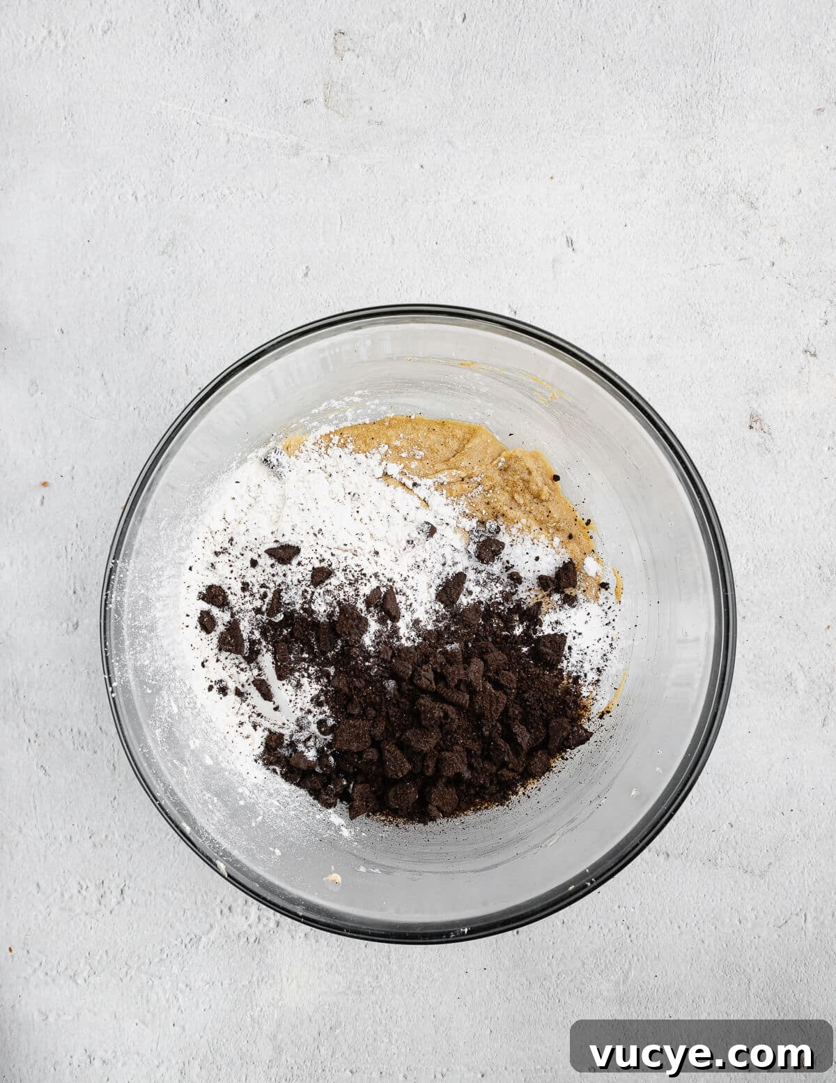 Oreo Chocolate Chip Cookies Recipe — Crispy Edges, Chewy Center 11 creamed butter and sugar in a bowl with dry ingredients and Oreo cookie crumbs on top.