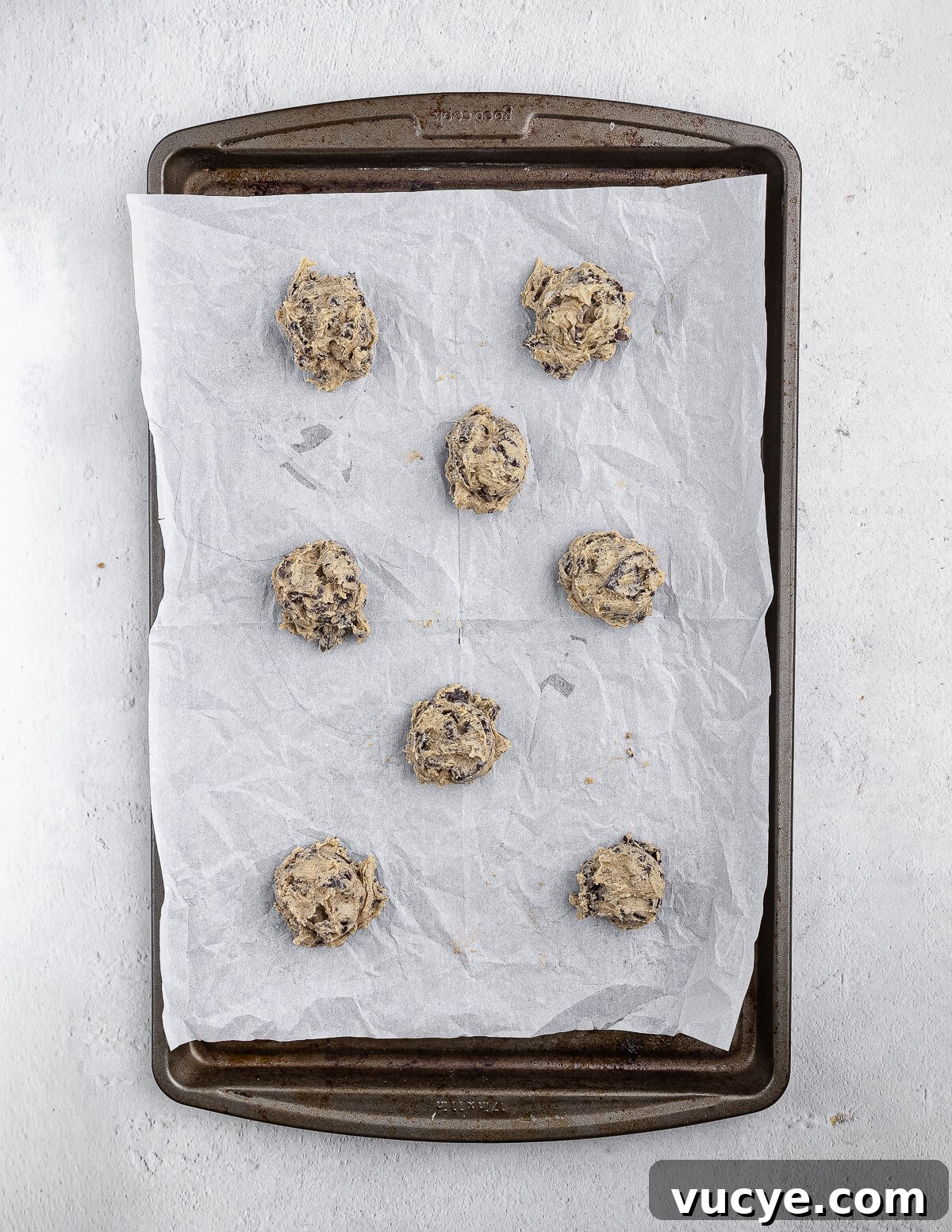 Oreo Chocolate Chip Cookies Recipe — Crispy Edges, Chewy Center 15 Chocolate chip Oreo cookie dough balls on a parchment lined sheet pan.