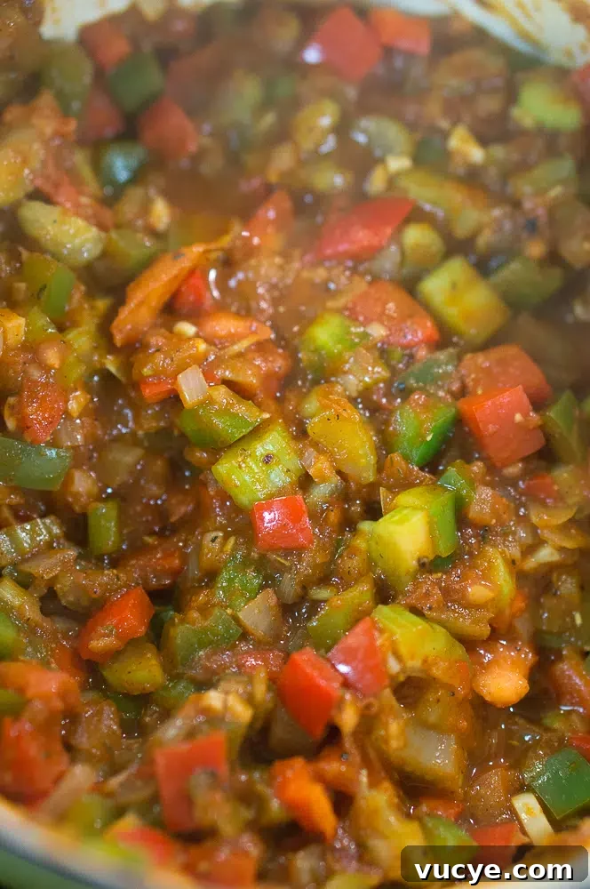 The vegetables mixed with the spices and tomato paste