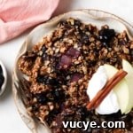 Apple and Blueberry Crumble Recipe: Light, Fruity Dessert Guide 15 Apple and blueberry crumble on a plate with whipped cream and apple slices on top.