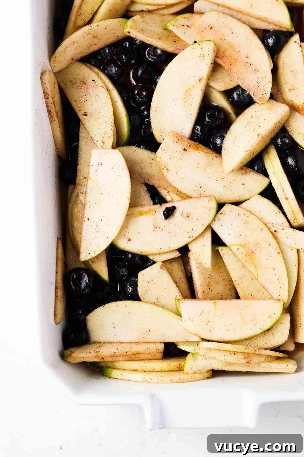 Apple and Blueberry Crumble Recipe: Light, Fruity Dessert Guide 7 Mixed blueberries and apple mixture in a casserole dish.