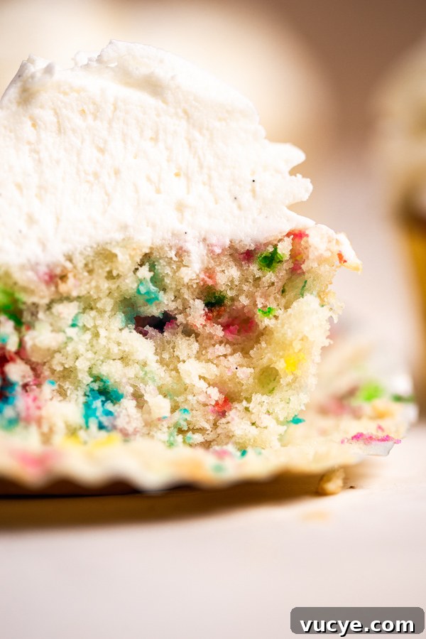 Funfetti Cupcakes with Vanilla Bean Buttercream Frosting 4 Scooping batter