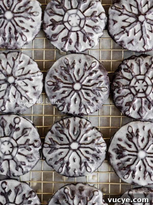 Classic Chewy Snickerdoodle Cookie Recipe for Perfect Cinnamon Cookies 12 Overhead image of homemade glazed oreo snowflake cookies on a wire cooling rack.