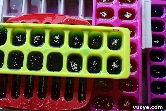 Frozen Fractals: Creative Ice Sculpture Activities for Kids 3 coloured, glittery ice cubes for a science activity