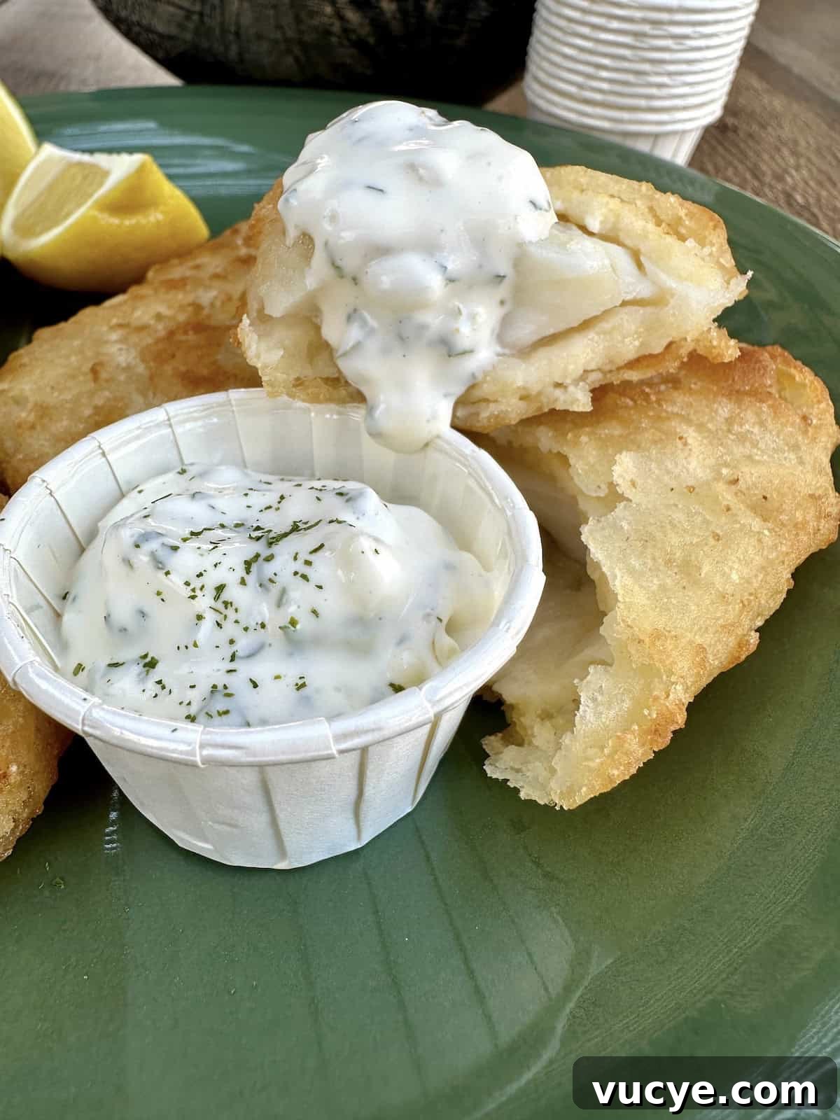 Homemade Tartar Sauce Recipe for Fish and Seafood 2 Tartar sauce in a small cup on a plate with fried fish.