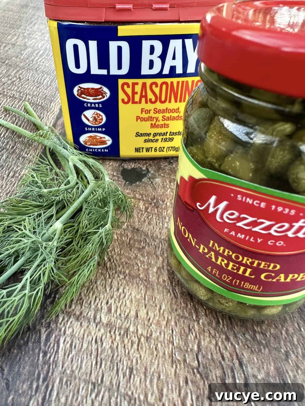 Homemade Tartar Sauce Recipe for Fish and Seafood 5 Dill, a container of Old Bay Seasoning and a jar of capers.