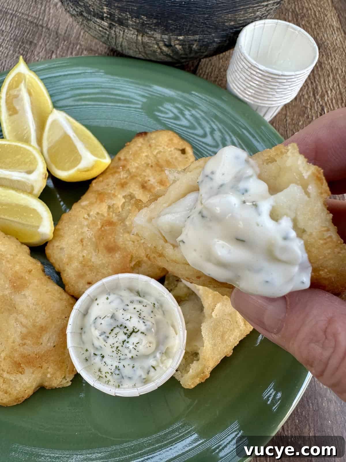 Homemade Tartar Sauce Recipe for Fish and Seafood 8 Fried fish and a small cup of tartar sauce on a plate.