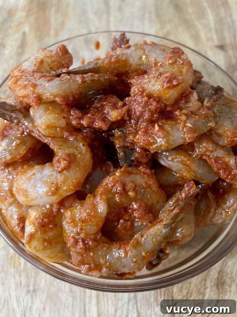 Bowl of marinated shrimp for shrimp fra diavolo recipe.