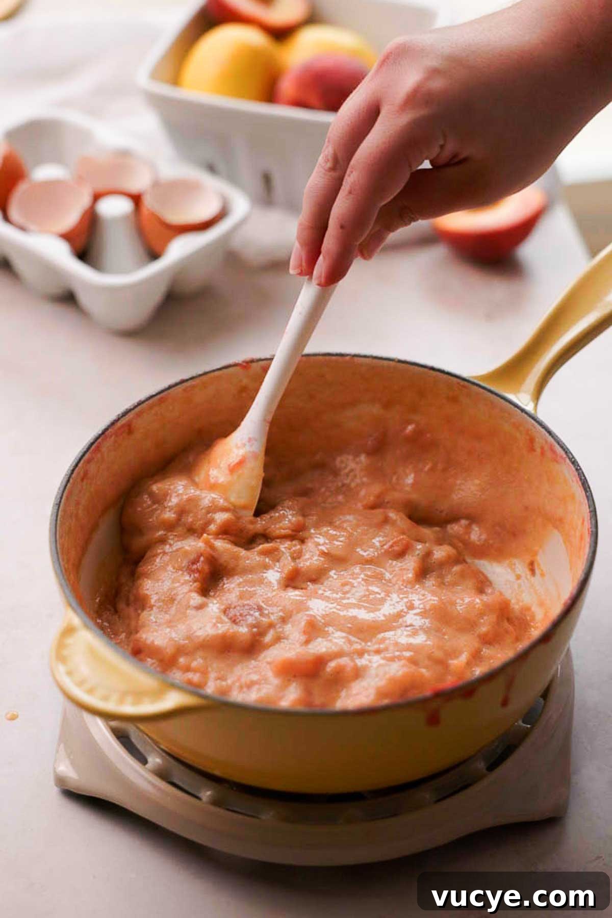 Silky Homemade Peach Curd Recipe for Tarts & Toast 11 cooking peach and egg mixture in a saucepan