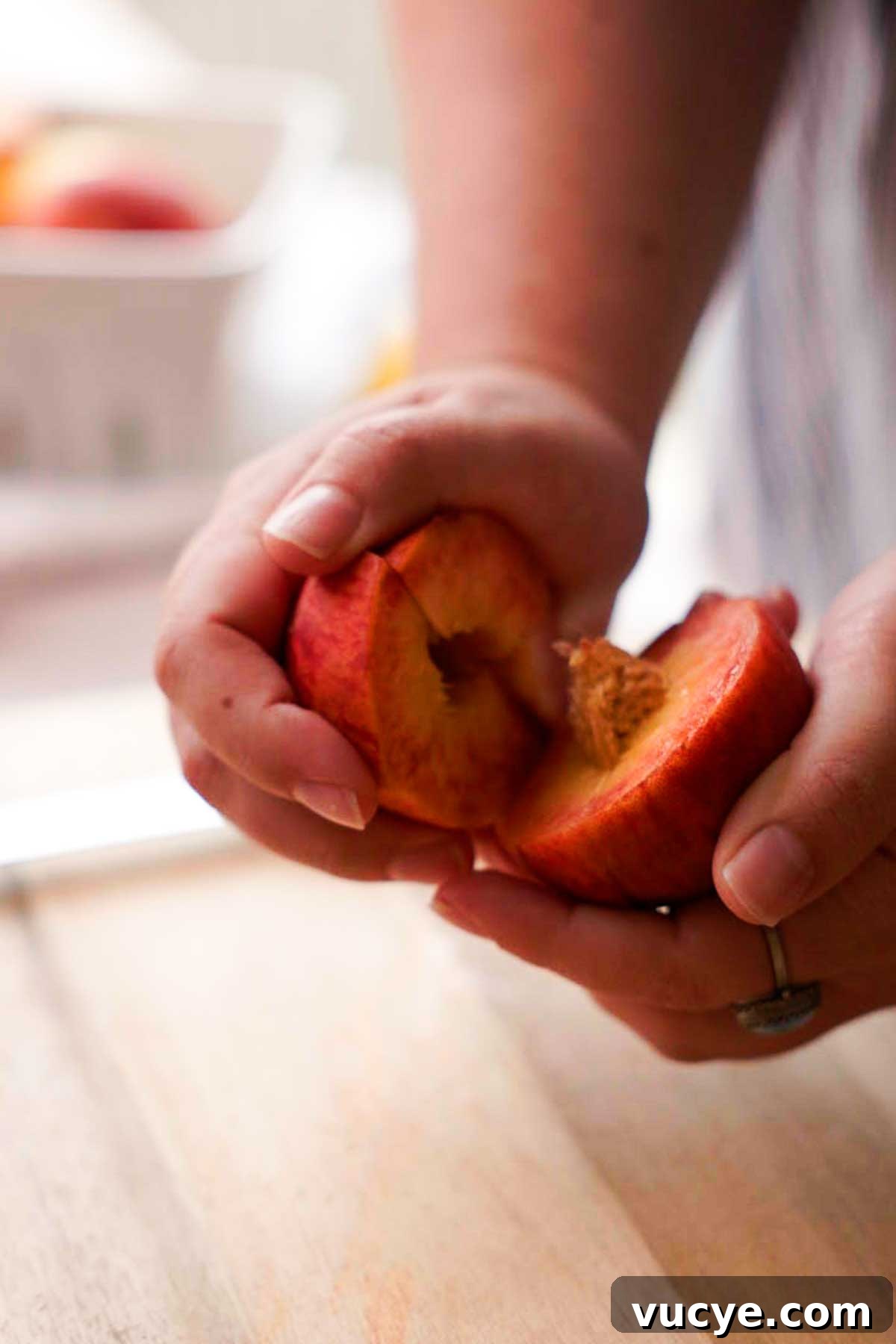 Silky Homemade Peach Curd Recipe for Tarts & Toast 6 cutting and twisting peach to separate the peaces