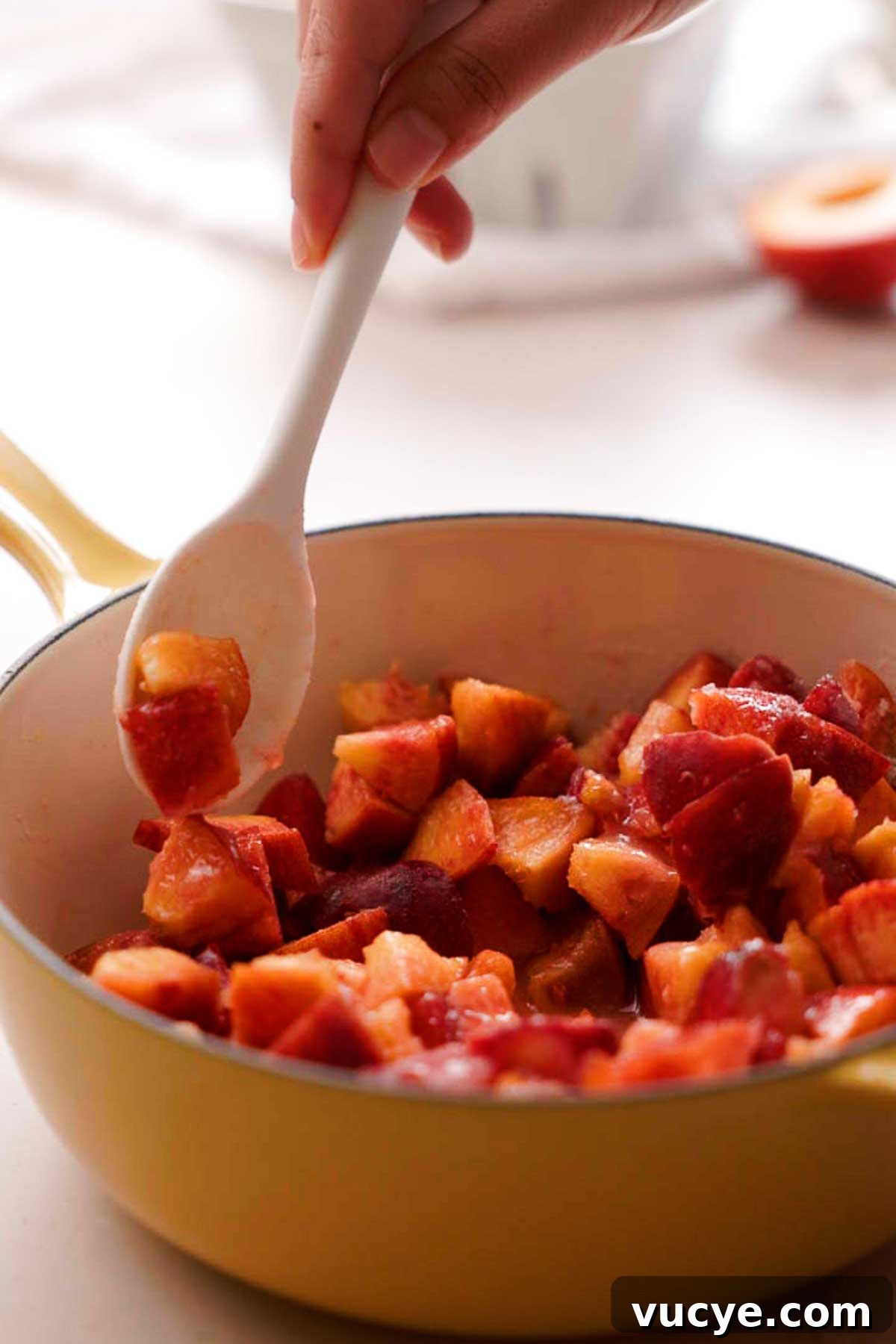 Silky Homemade Peach Curd Recipe for Tarts & Toast 7 stirring cut peaches, sugar and lemon juice in a saucepan