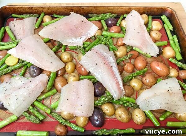 Sheet Pan Pickerel with Asparagus in 5 Ingredients 3 the fish on top of potatoes and asparagus