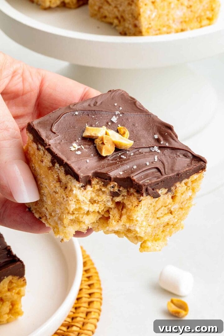 A bite taken out of a chocolate peanut butter Rice Krispie treat.