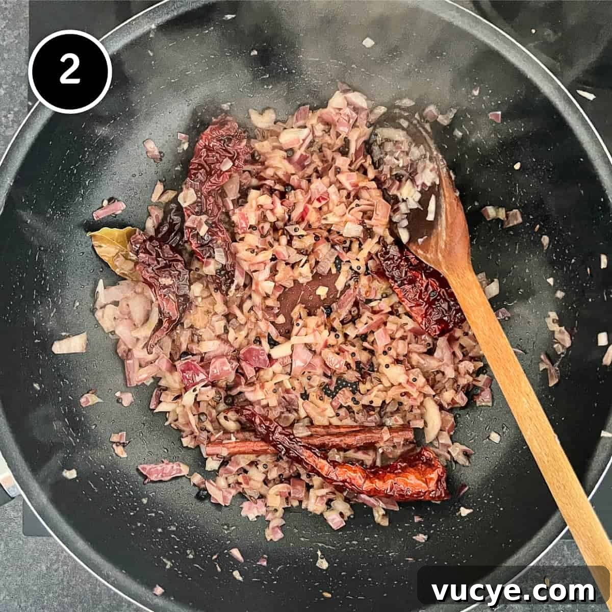 Chicken & Lentil Curry | cookeatworld.com Bring onion in whole spices in a pan with a wooden spoon