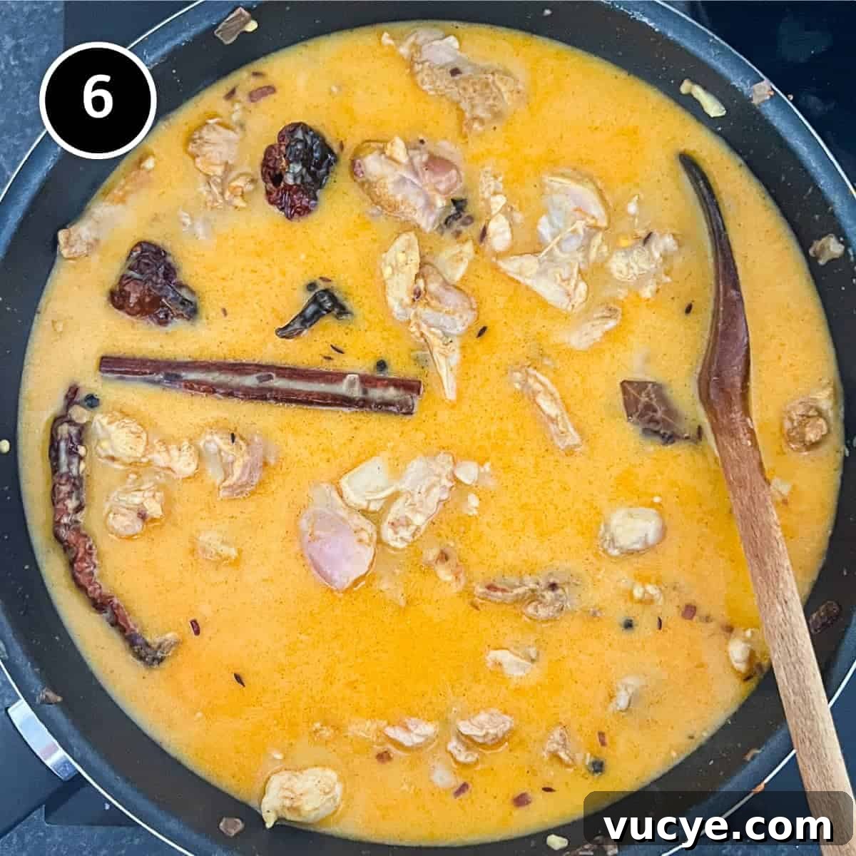 Chicken & Lentil Curry | cookeatworld.com A pan of gently simmering chicken and lentil curry