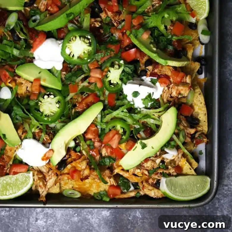 Sheet Pan Chicken Nachos with Loaded Toppings 5 close up of loaded chicken nachos