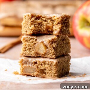 Apple Cinnamon Blondie Recipe — Chewy Spiced Apple Bars 15 A stack of cinnamon apple blondies. The top bar has a bite removed.