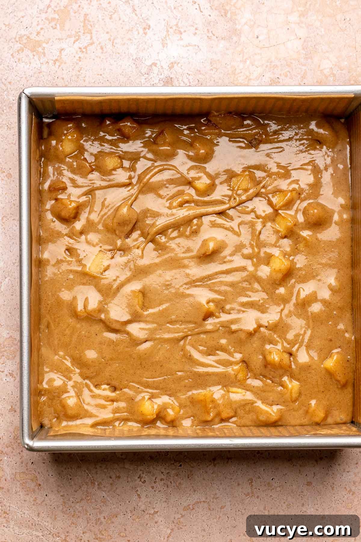 Apple Cinnamon Blondie Recipe — Chewy Spiced Apple Bars 7 Pre-baked cinnamon apple blondie batter in a pan.