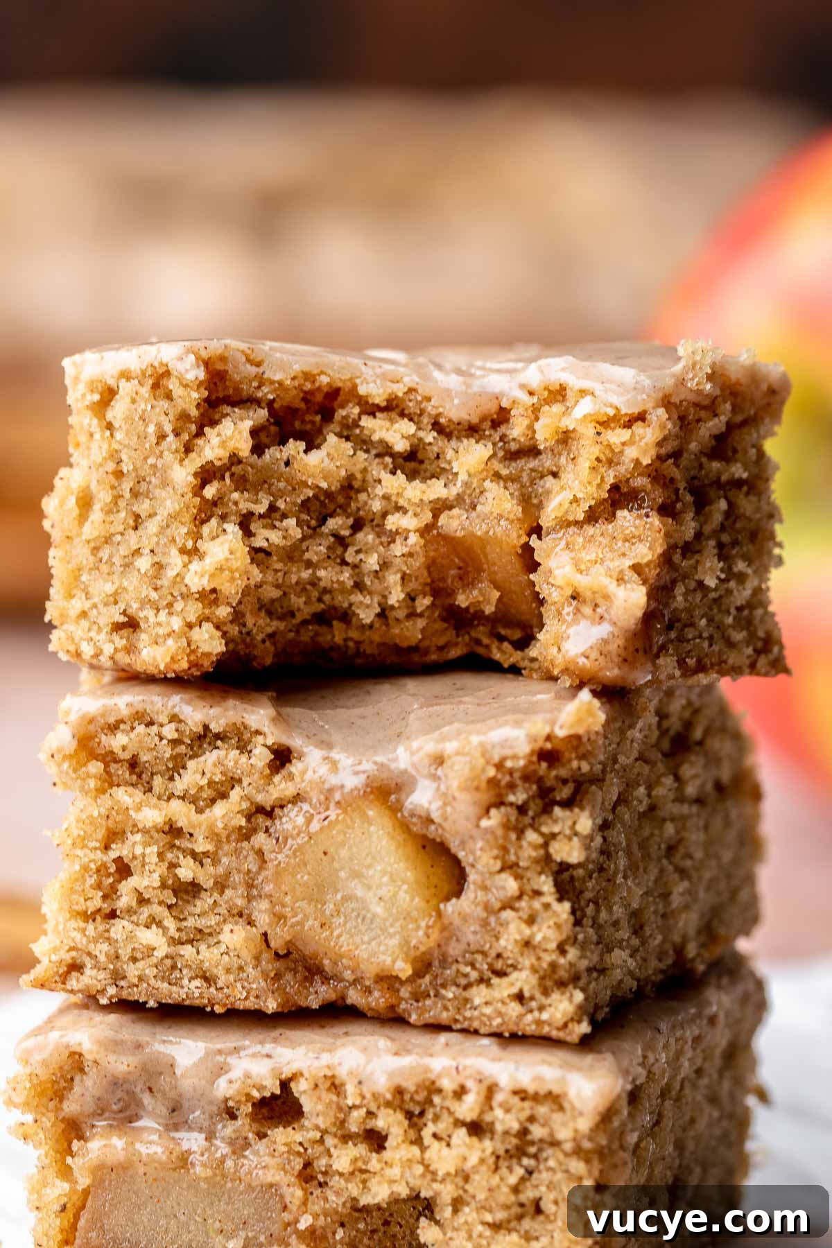 Apple Cinnamon Blondie Recipe — Chewy Spiced Apple Bars 10 A stack of cinnamon apple blondies. The top bar has a bite removed.